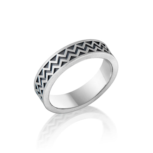 Silver ring with a chevron pattern referencing Maya Hieroglyphs with satin oxidized finish on a white background